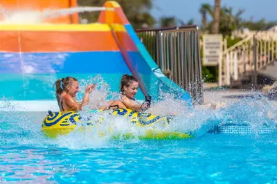 two children on a water slide in the water at Ali Baba Palace Resort in Hurghada