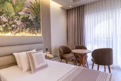 a hotel room with a bed and a table and chairs at Ali Baba Palace Resort in Hurghada