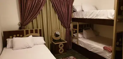 a bedroom with two bunk beds and a mirror at Al Dora Residence Appartement in Hurghada