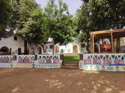 a park with a fence with graffiti on it at Maghrabi's Guest house in Aswan