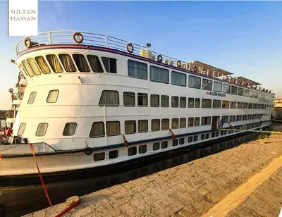 a large cruise ship docked in the water at Nile Cruise King Tut in Luxor
