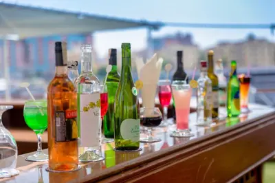 a row of wine bottles and glasses on a bar at Nile Cruise King Tut in Luxor