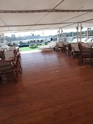 a large deck with chairs and tables on a boat at King Tut I Nile Cruise - Every Monday 4 Nights from Luxor - Every Friday 7 Nights from Aswan in Luxor