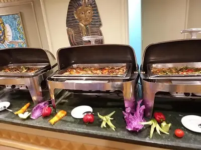 two trays of food on a counter with vegetables at King Tut I Nile Cruise - Every Monday 4 Nights from Luxor - Every Friday 7 Nights from Aswan in Luxor