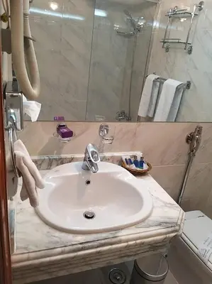 a bathroom with a white sink and a mirror at King Tut I Nile Cruise - Every Monday 4 Nights from Luxor - Every Friday 7 Nights from Aswan in Luxor