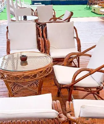 a group of wicker chairs and a table and chairs at King Tut I Nile Cruise - Every Monday 4 Nights from Luxor - Every Friday 7 Nights from Aswan in Luxor