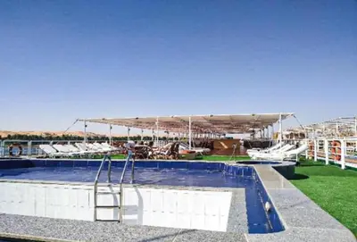 a swimming pool with a large canopy over it at King Tut I Nile Cruise - Every Monday 4 Nights from Luxor - Every Friday 7 Nights from Aswan in Luxor