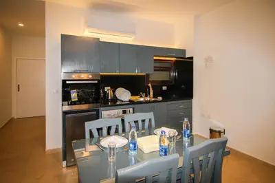 a kitchen with a table with chairs and a counter top at SeaView Turtles in Hurghada