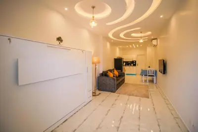 a living room with a large white wall at SeaView Turtles in Hurghada