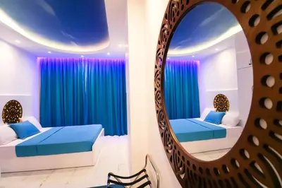 a bedroom with two beds and a mirror at SeaView Turtles in Hurghada