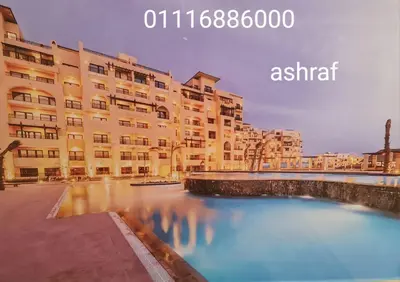 a large building with a river in front of it at Aldau Heights in Hurghada