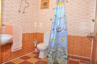 a bathroom with a toilet and a shower curtain at Ali Baba Safaga Hotel in Hurghada
