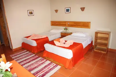 two beds in a room with red and white at Ali Baba Safaga Hotel in Hurghada