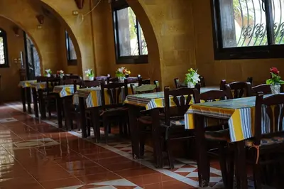a row of tables and chairs in a restaurant at Ali Baba Safaga Hotel in Hurghada
