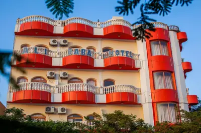 a building with red balconies on the side of it at Ali Baba Safaga Hotel in Hurghada