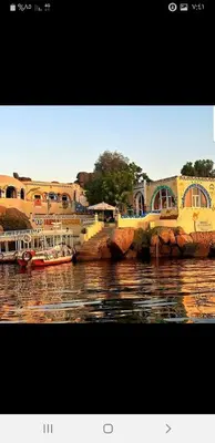 a group of boats in a body of water at Old Nubian guest house in Aswan
