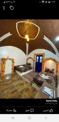 a picture of a room with two beds in it at Old Nubian guest house in Aswan