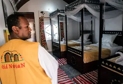a man standing in a room with two bunk beds at Old Nubian guest house in Aswan