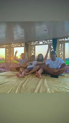 a group of people sitting on top of a bed at Nile Sunrise Flats And Rooms in Luxor