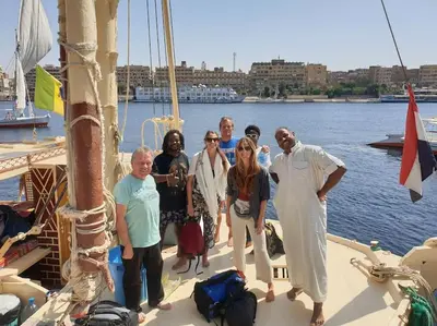 a group of people standing on the deck of a boat at Bob Marley Guest House in Aswan