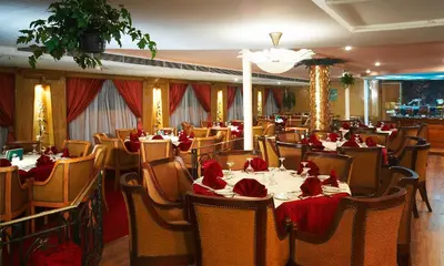 a restaurant with tables and chairs with red napkins on them at Nile Carnival Cruise 4nt Lxr Thursday 3nt Asw Monday in Luxor