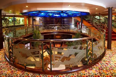 a large lobby with a spiral staircase in a building at Nile Carnival Cruise 4nt Lxr Thursday 3nt Asw Monday in Luxor