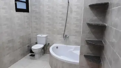 a bathroom with a toilet and a bath tub at Enjoy Luxor in Luxor