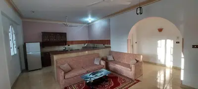 a living room with a couch and a kitchen at Enjoy Luxor in Luxor