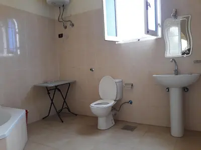 a bathroom with a toilet and a sink and a mirror at Enjoy Luxor in Luxor
