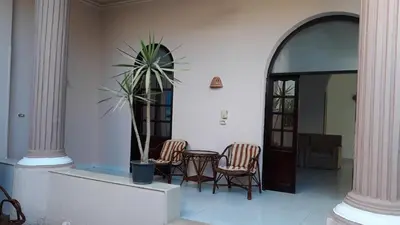 a room with two chairs and a table and a plant at Enjoy Luxor in Luxor
