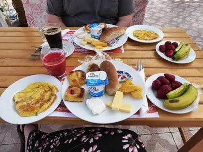 a table with plates of breakfast food on it at Enjoy Luxor in Luxor