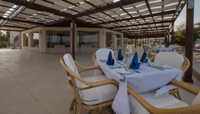 a table with chairs and a white table cloth at Shams Lodge in Hurghada
