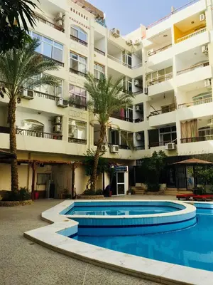 an apartment building with a swimming pool in front of it at Solider Art in Hurghada