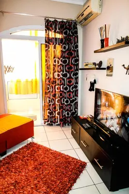 a living room with a fish tank and a tv at Desert Pearl Art in Hurghada