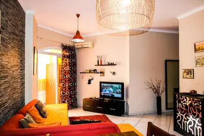 a living room with a couch and a television at Desert Pearl Art in Hurghada