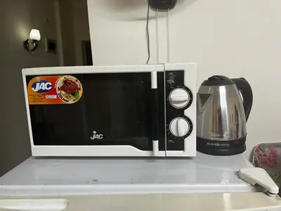 a microwave sitting on top of a counter at Lotus compound in Hurghada