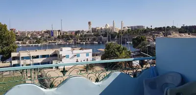 a balcony with a view of a river and a city at The Green Nubian House in Aswan