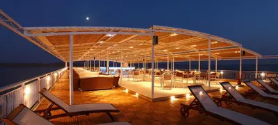 a deck with chairs and tables on a boat at Steigenberger Omar El Khayam Nile Cruise - Every Monday from Aswan for 07 & 04 Nights - Every Friday From Abu Simbel for 03 Nights in Aswan