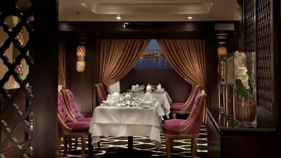 a dining room with two tables and purple chairs at Steigenberger Minerva Nile Cruise - Every Thursday from Luxor for 07 & 04 Nights - Every Monday From Aswan for 03 Nights in Luxor