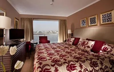 a hotel room with a bed and a television at Steigenberger Minerva Nile Cruise - Every Thursday from Luxor for 07 & 04 Nights - Every Monday From Aswan for 03 Nights in Luxor