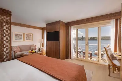 a hotel room with a bed and a large window at JAZ Elite Senator Nile Cruises - Every Thursday from Luxor for 07 Nights & Every Thursday from Luxor for 05 Nights in Luxor