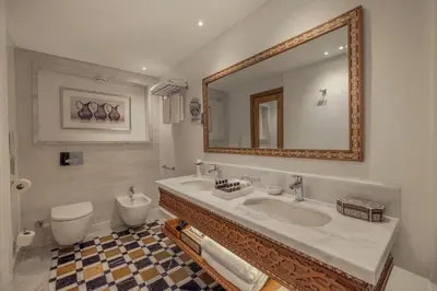 a bathroom with a sink and a toilet and a mirror at JAZ Elite Senator Nile Cruises - Every Thursday from Luxor for 07 Nights & Every Thursday from Luxor for 05 Nights in Luxor