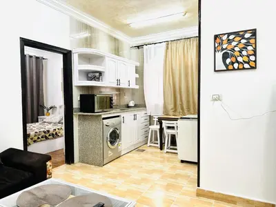 a small kitchen with a washer and dryer in a room at Karibu House Sheraton Road in Hurghada