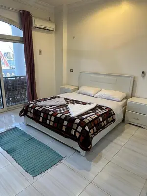 a bedroom with a bed with a blanket on it at Soliman Nile View in Luxor