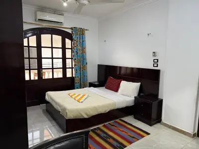 a bedroom with a bed and a window at Soliman Nile View in Luxor