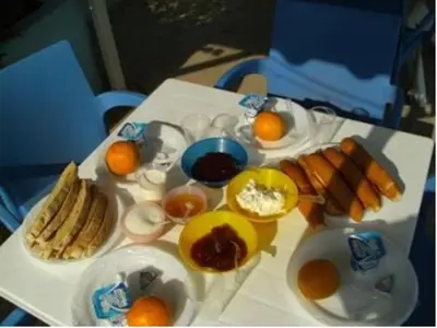 a table with eggs and other food on it at Bob Marley House Sherief Hotel Luxor in Luxor