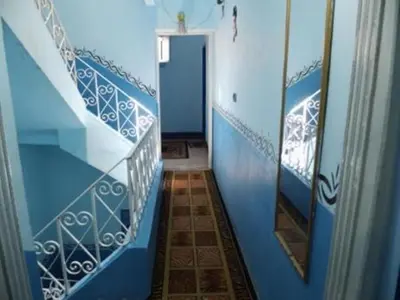 a hallway with blue and white walls and a mirror at Bob Marley House Sherief Hotel Luxor in Luxor