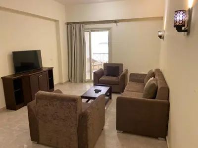 a living room with two couches and a television at Bahga Palace 1 Residential Apartments in Hurghada