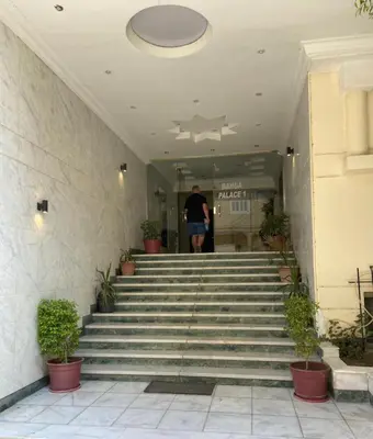 a man walking up the stairs of a building at Bahga Palace 1 Residential Apartments in Hurghada