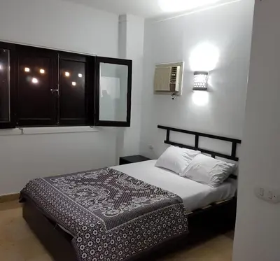 a bedroom with a bed and a window at Apartments in Almaz Plaza in Hurghada